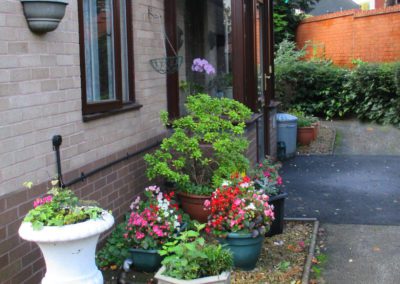 Flower pots outside a dwelling at Carrs Lane Gardens